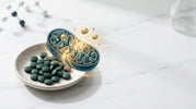 Spirulina tablets and artistic visualization of mitochondria producing ATP energy molecules, representing how spirulina supports natural cellular energy production