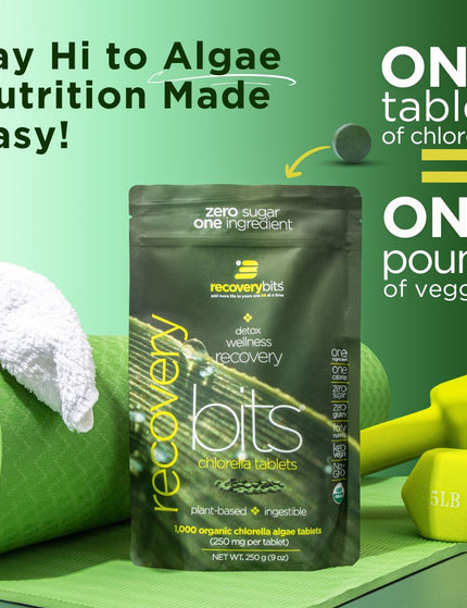 RecoveryBits chlorella tablets bag displayed with a yoga mat, towel, and dumbbells, highlighting that one tablet of chlorella equals one pound of veggies.